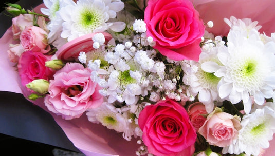 A bouquet of pink roses and white flowers