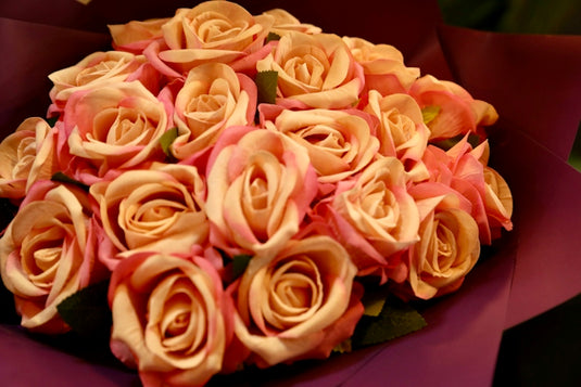 A bouquet of pink and peach roses.