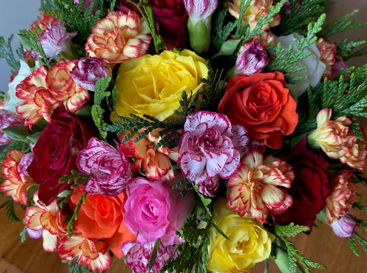a vase filled with lots of colorful flowers