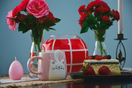 a table topped with a cake and flowers