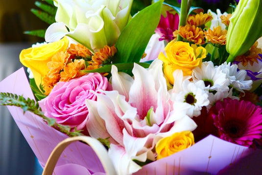 A bouquet of colorful flowers in a basket