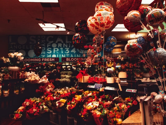 A store filled with lots of balloons and flowers