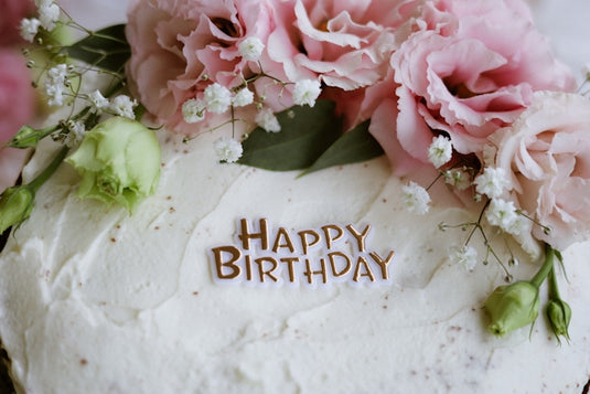 A birthday cake decorated with flowers.