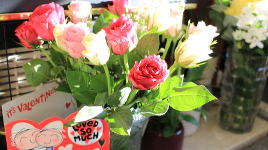 Bouquet of pink and white roses with valentine's card